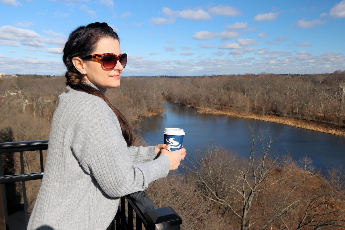 Heather from Better Living enjoying a coffee on the lake view suite balcony at the Merriweather Lakehouse Hotel 